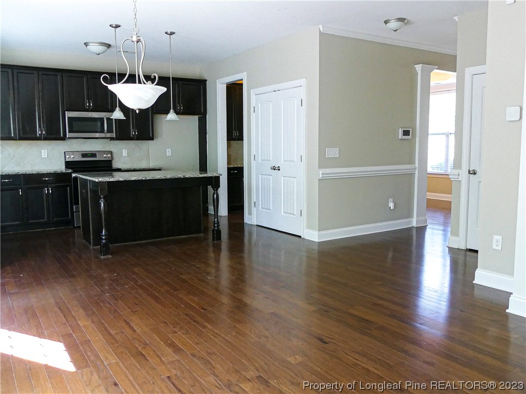 80 Pedley Place Cameron, NC 28326 - Photo 12 of 34 a view of a kitchen and an empty room with wooden floor