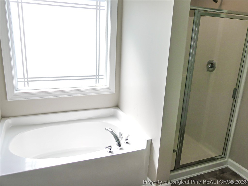 80 Pedley Place Cameron, NC 28326 - Photo 21 of 34 a bathroom with a bathtub and a shower