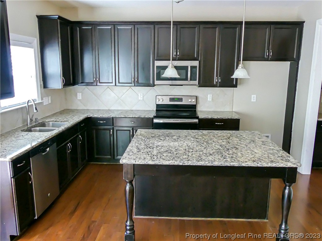 80 Pedley Place Cameron, NC 28326 - Photo 8 of 34 a kitchen with kitchen island granite countertop a sink stove and microwave