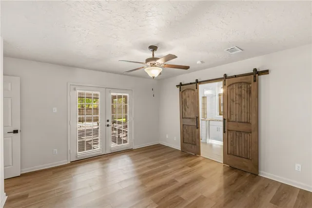 a bedroom with a large bed and a chandelier
