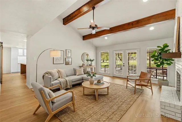 a living room with a fireplace and a wooden floor