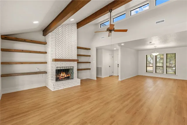 wooden floor in an empty room with a window