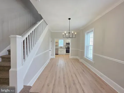 a view of a livingroom with wooden floor and staircase