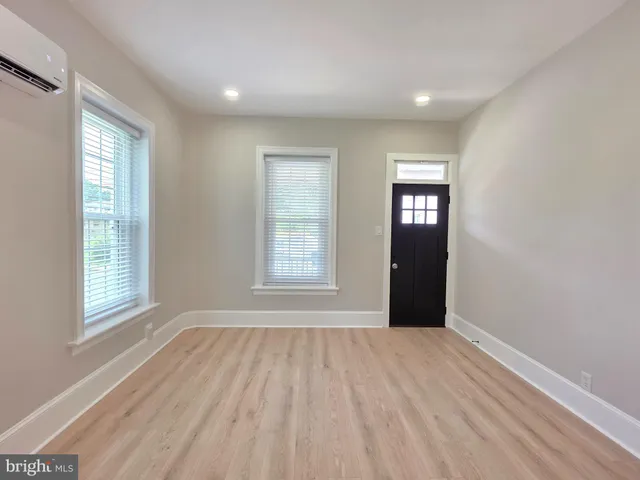 an empty room with windows and closet