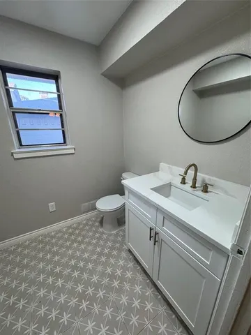 a bathroom with a sink mirror and vanity