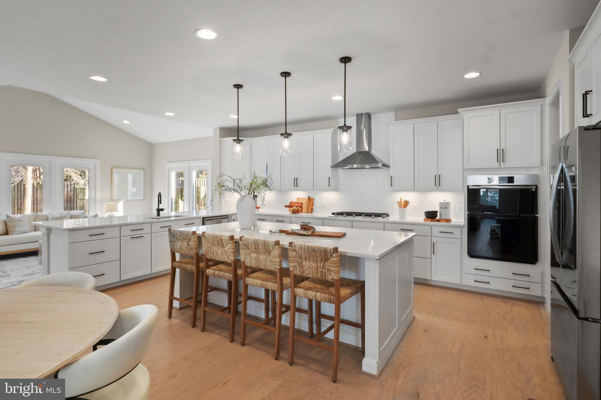 602 Kingsley Road Southwest Vienna, VA 22180 - Photo 22 of 79 a kitchen with stainless steel appliances kitchen island granite countertop a table chairs sink and cabinets