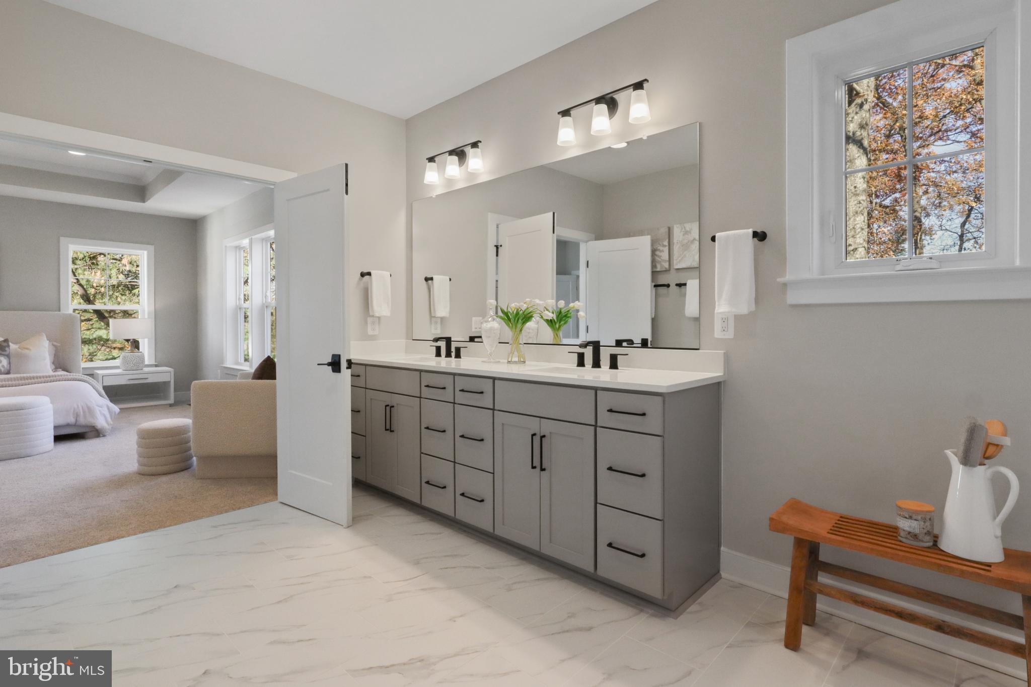 602 Kingsley Road Southwest Vienna, VA 22180 - Photo 39 of 79 a spacious bathroom with a double vanity sink a mirror a bathtub and window