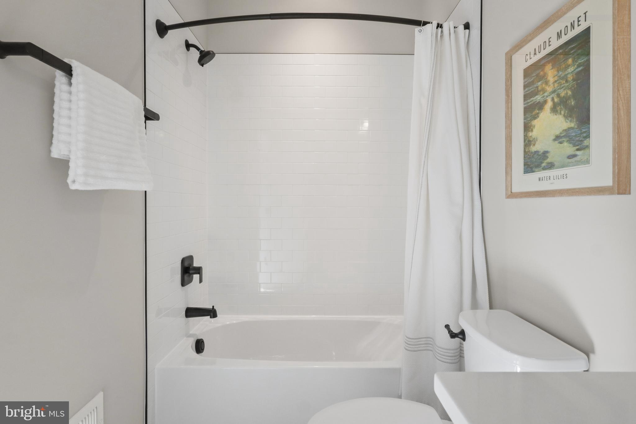 602 Kingsley Road Southwest Vienna, VA 22180 - Photo 48 of 79 a bathroom with a bathtub and a shower