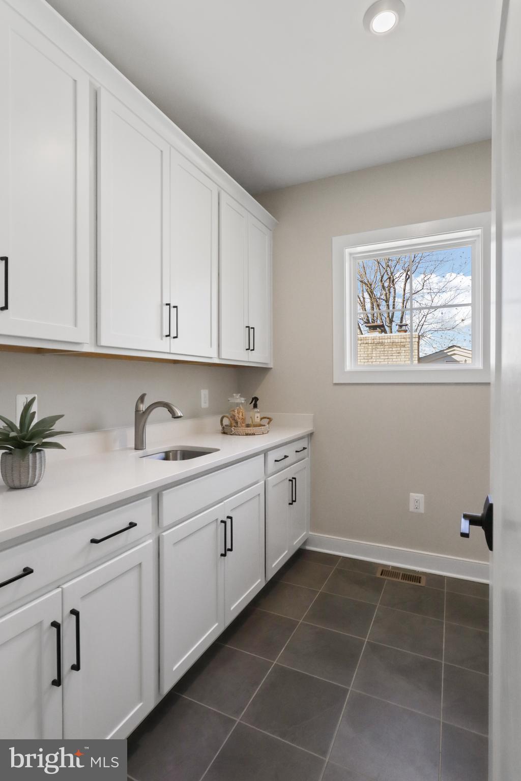 602 Kingsley Road Southwest Vienna, VA 22180 - Photo 70 of 79 a room with granite countertop white cabinets stainless steel appliances and a window