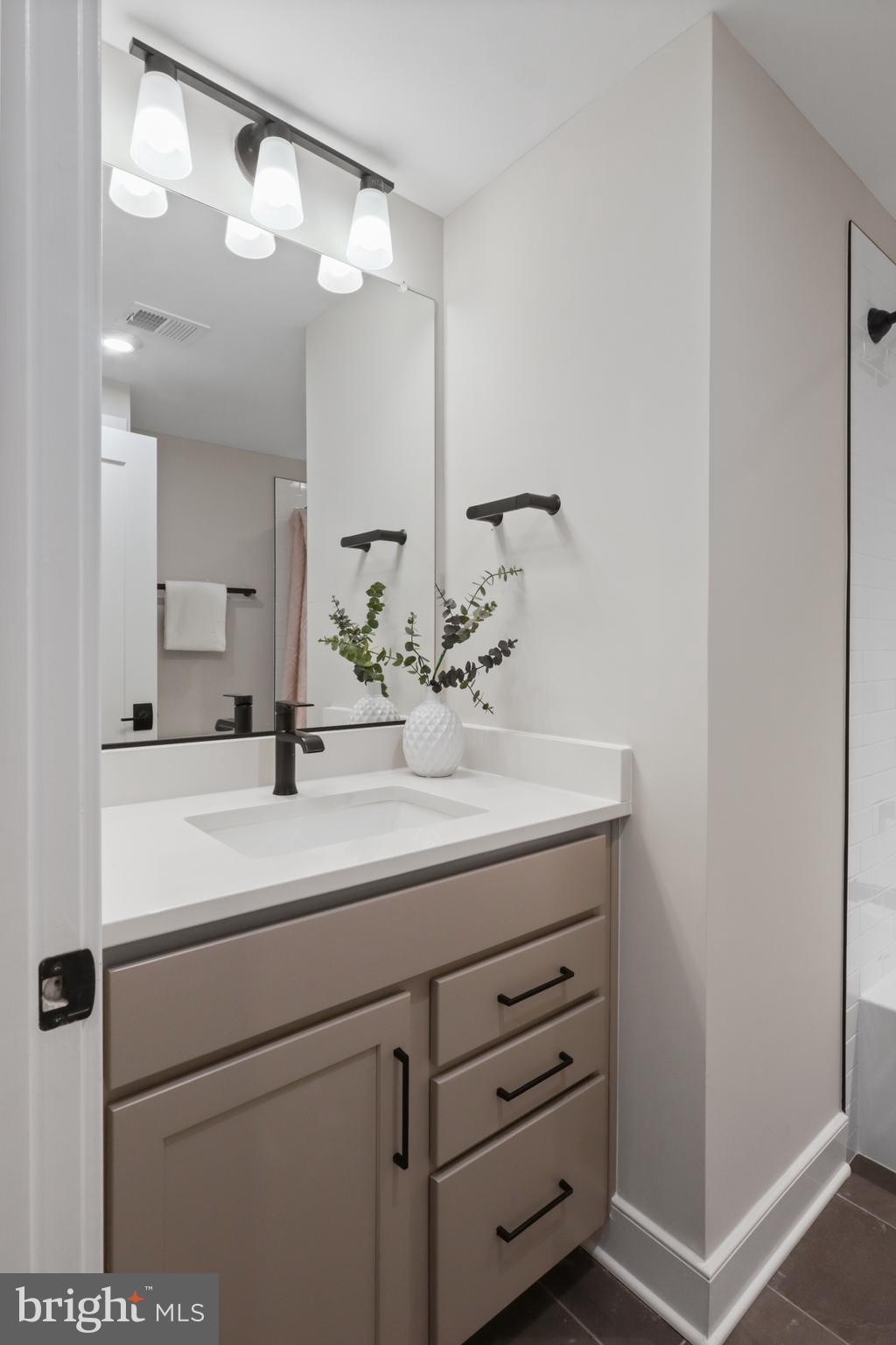 602 Kingsley Road Southwest Vienna, VA 22180 - Photo 79 of 79 a bathroom with a sink and a mirror