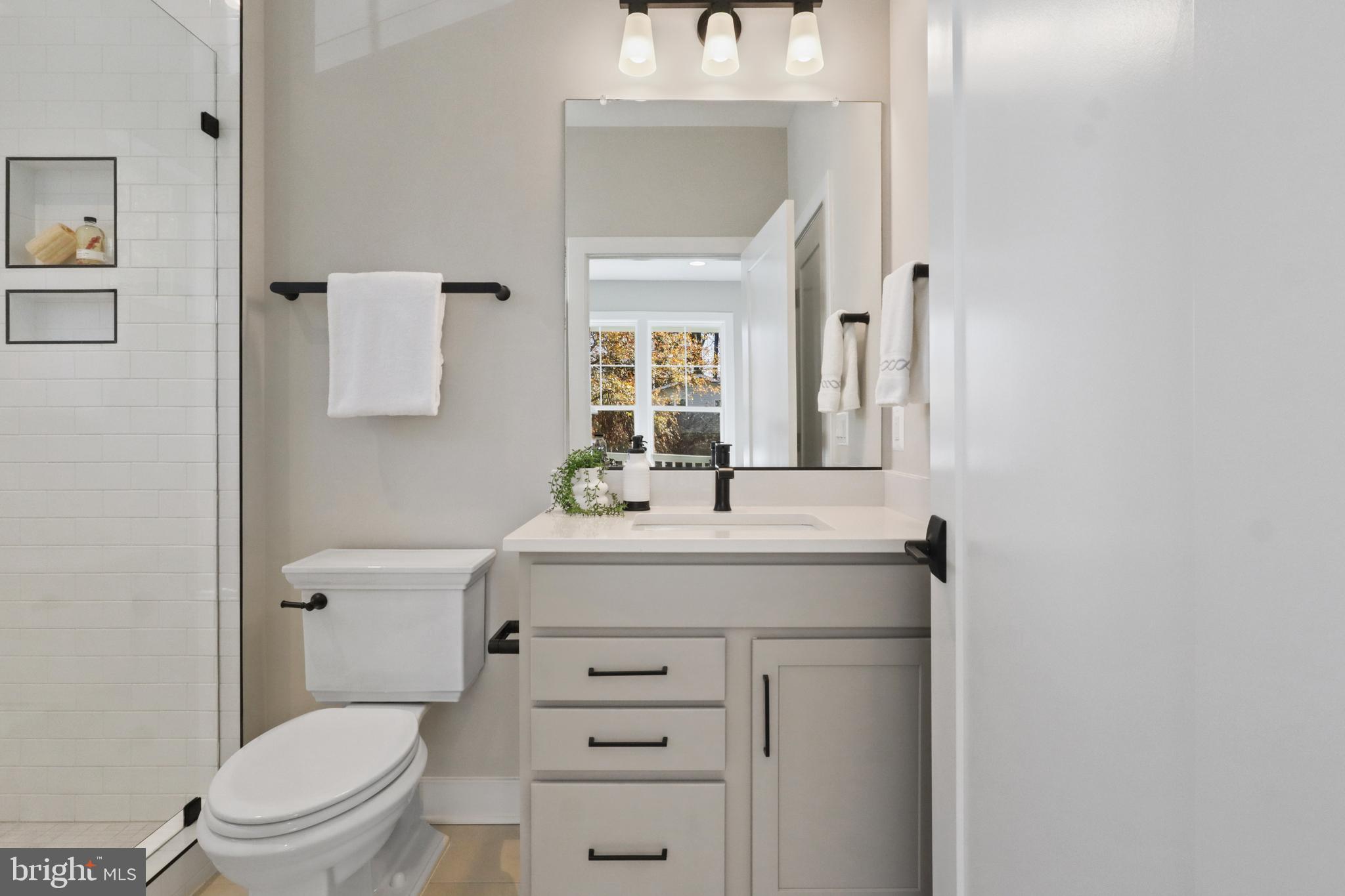 602 Kingsley Road Southwest Vienna, VA 22180 - Photo 10 of 79 a bathroom with a granite countertop toilet sink and mirror