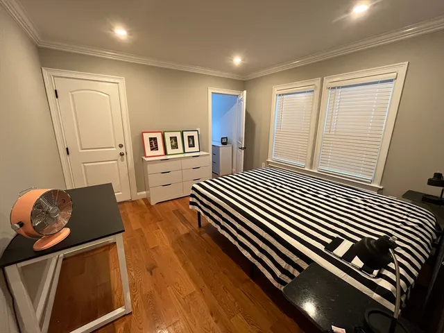 a bedroom with two beds and a window