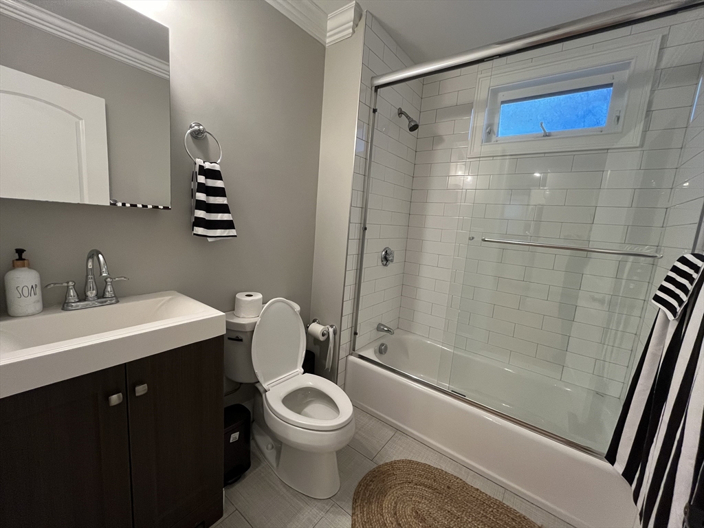 23 Rockledge Street, Unit 1 Boston, MA 02119 - Photo 7 of 8 a bathroom with a sink a toilet and shower