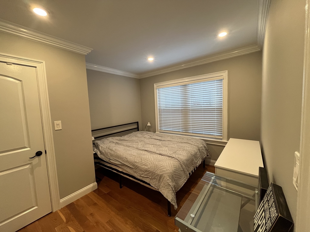 23 Rockledge Street, Unit 1 Boston, MA 02119 - Photo 8 of 8 a bedroom with a bed and wooden floor