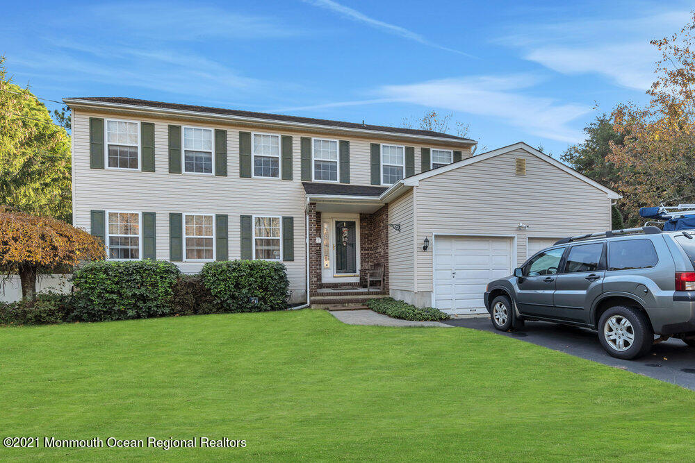 587 Reed Road Jackson, NJ 08527 - Photo 1 of 26 a front view of a house with garden