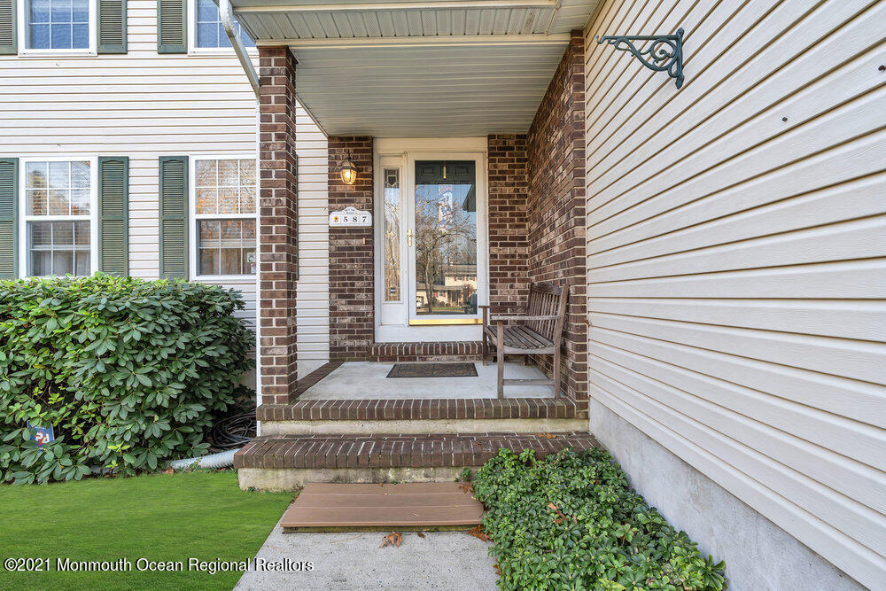587 Reed Road Jackson, NJ 08527 - Photo 2 of 26 a front view of a house with a garden