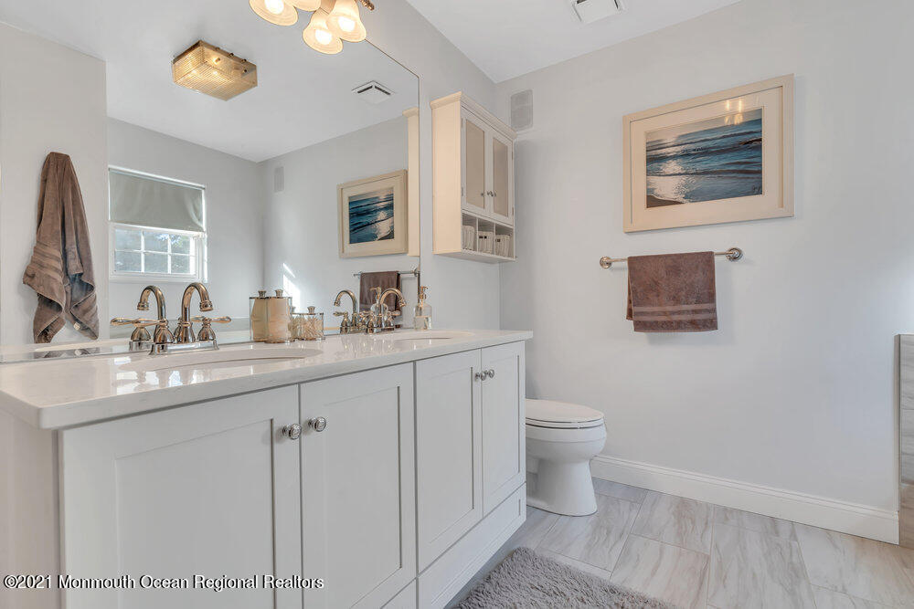 587 Reed Road Jackson, NJ 08527 - Photo 12 of 26 a bathroom with a toilet sink and mirror