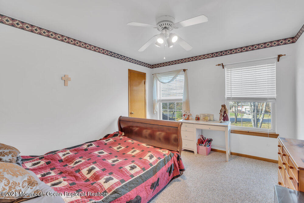 587 Reed Road Jackson, NJ 08527 - Photo 16 of 26 a bedroom with a bed and a window