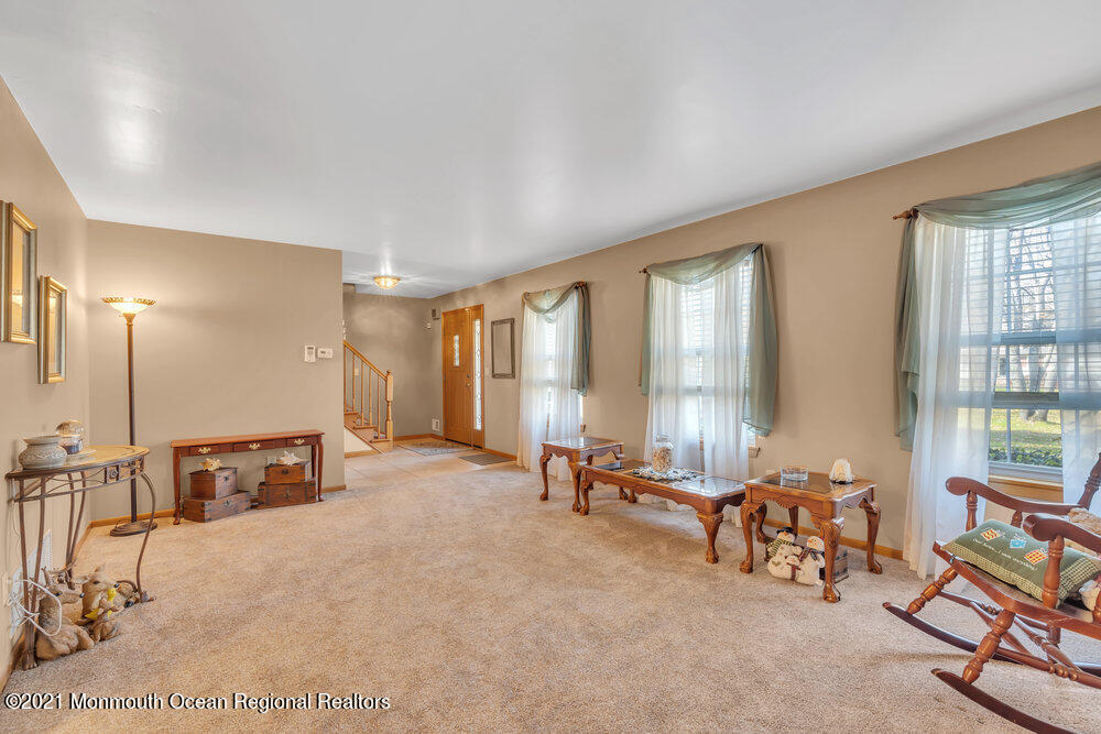 587 Reed Road Jackson, NJ 08527 - Photo 4 of 26 a view of a room with gym equipment and large windows
