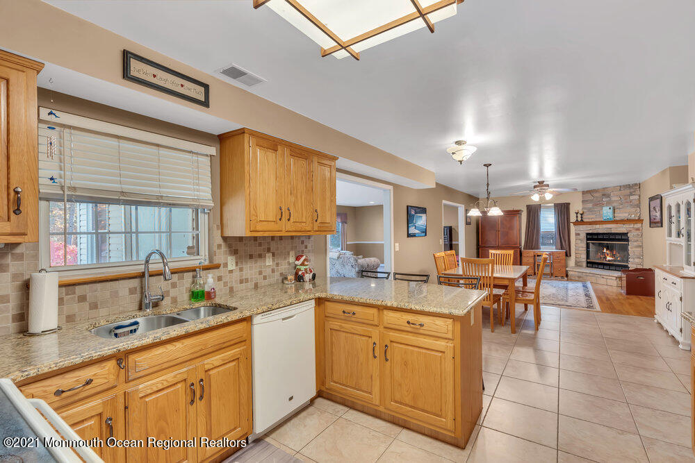587 Reed Road Jackson, NJ 08527 - Photo 6 of 26 a kitchen with a sink stove and cabinets
