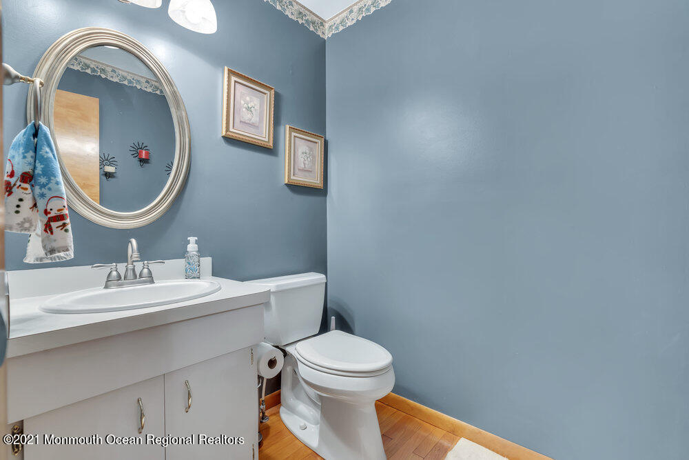 587 Reed Road Jackson, NJ 08527 - Photo 10 of 26 a bathroom with a toilet sink vanity and mirror