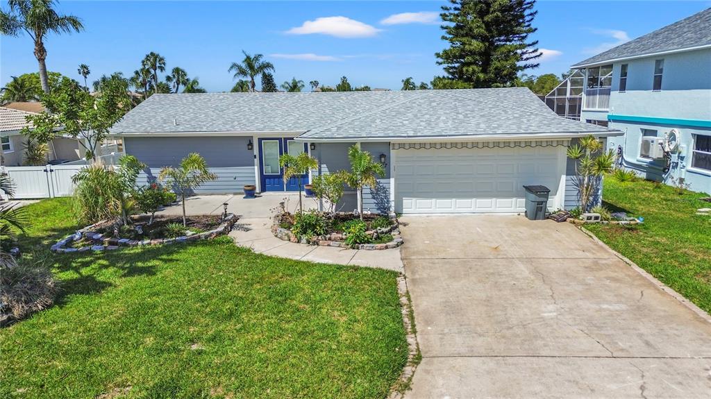 9917 San Sierra Way Port Richey, FL 34668 - Photo 11 of 33 front view of a house with a yard