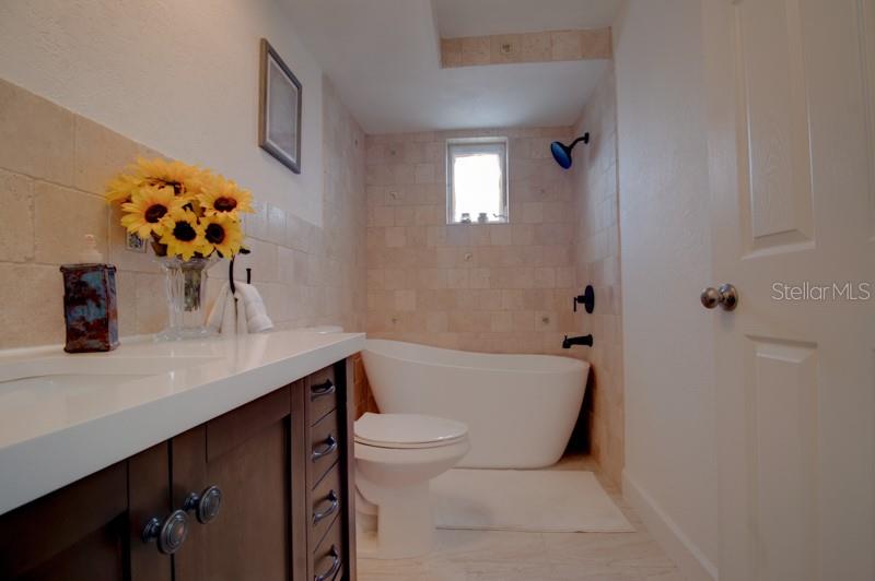 9917 San Sierra Way Port Richey, FL 34668 - Photo 15 of 33 a bathroom with a sink a toilet and mirror