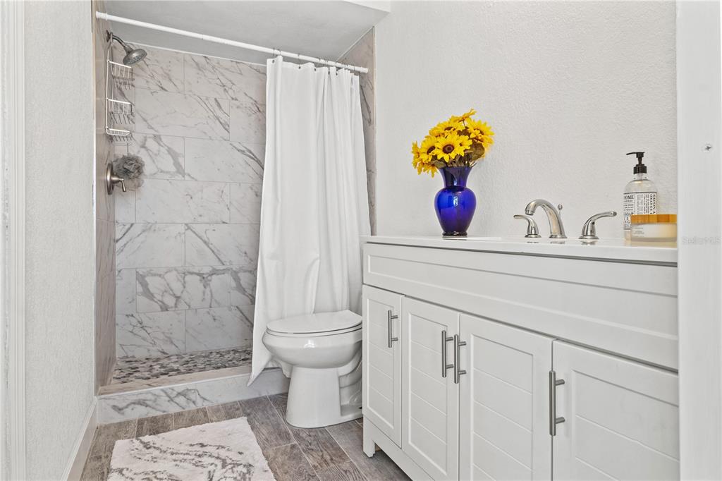 9917 San Sierra Way Port Richey, FL 34668 - Photo 18 of 33 a bathroom with a sink toilet and shower