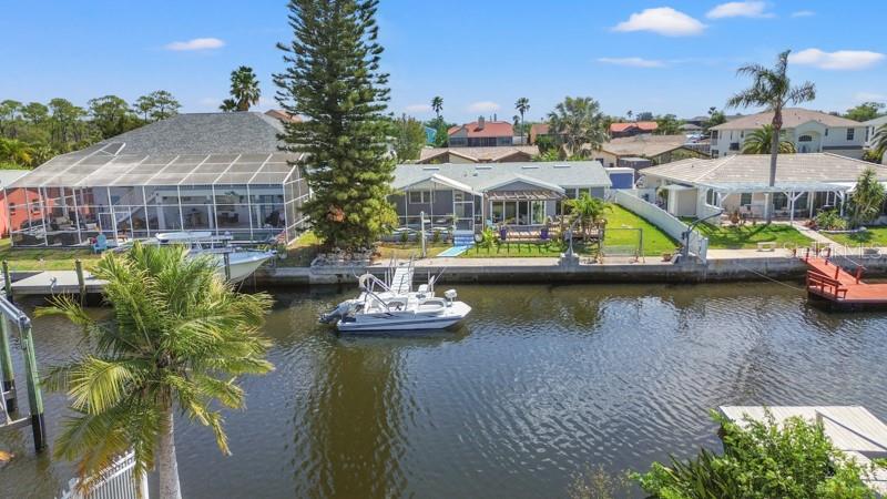 9917 San Sierra Way Port Richey, FL 34668 - Photo 27 of 33 a view of a lake with a house in the background