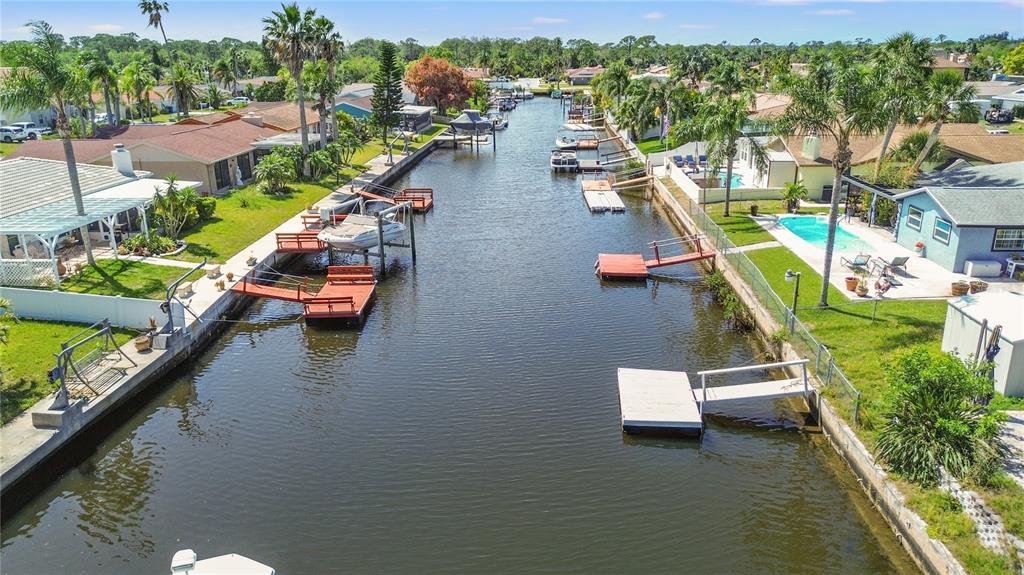 9917 San Sierra Way Port Richey, FL 34668 - Photo 30 of 33 an aerial view of a house with swimming pool and lake view