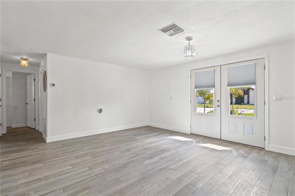 9917 San Sierra Way Port Richey, FL 34668 - Photo 6 of 33 an empty room with window and wooden floor