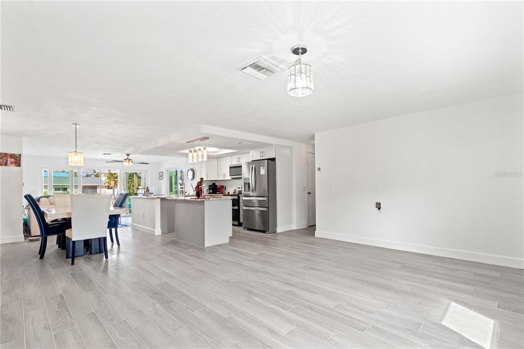 9917 San Sierra Way Port Richey, FL 34668 - Photo 7 of 33 a view of a dining room with furniture and wooden floor