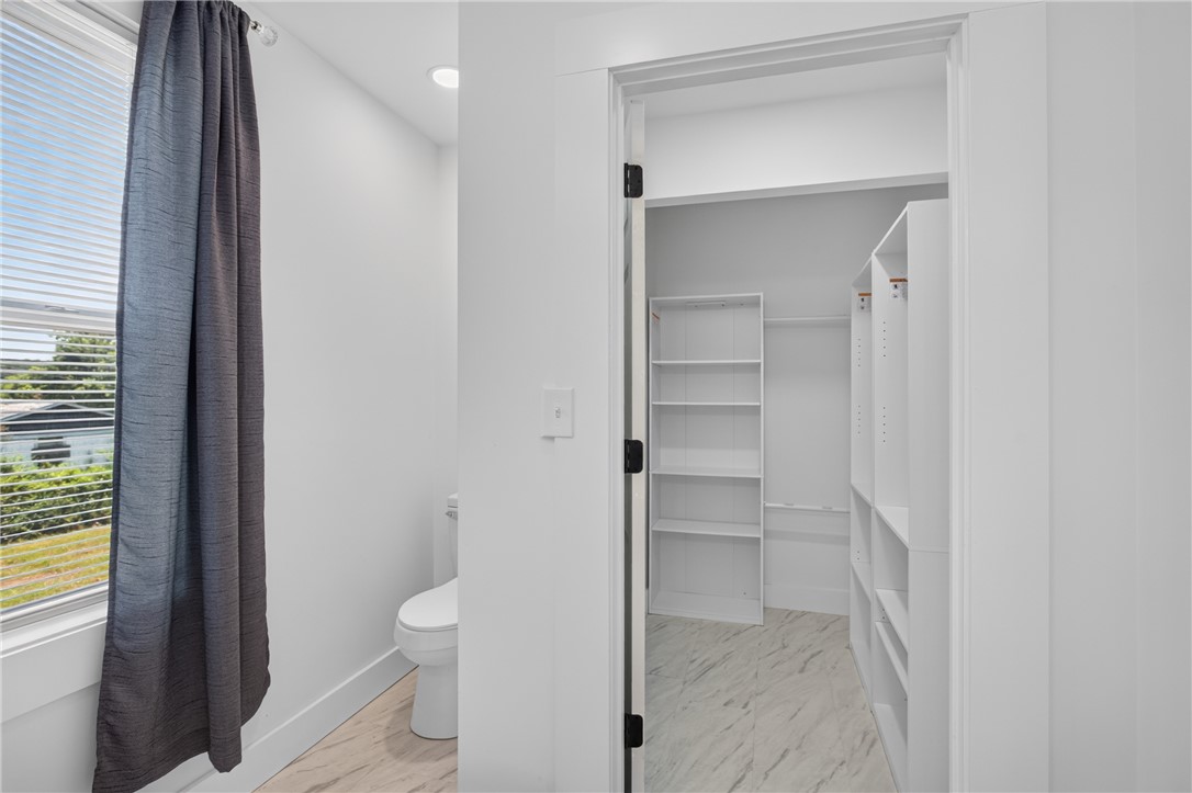 115 Pelfrey Street Seneca, SC 29672 - Photo 29 of 46 A well-lit walk-in closet offers ample storage and easy organization within this pristine bathroom.