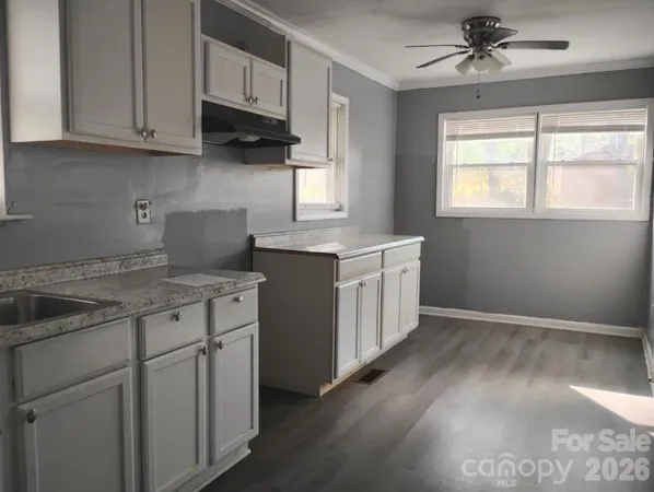 a kitchen with stainless steel appliances granite countertop a sink stove and cabinets