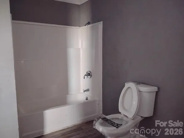 a bathroom with a toilet and a bathtub