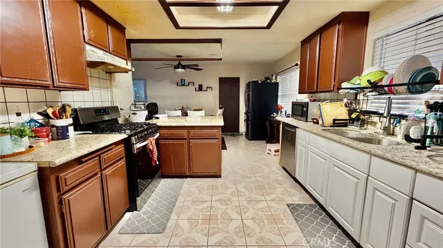 a kitchen with a sink refrigerator and microwave