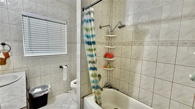 a view of a dry yard with wooden fence