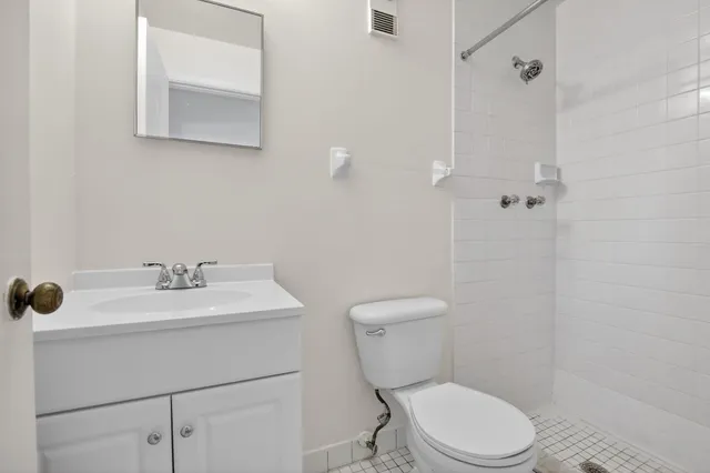 a white toilet sitting next to a bathroom sink