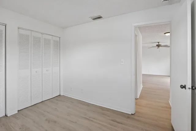 a view of a room with wooden floor