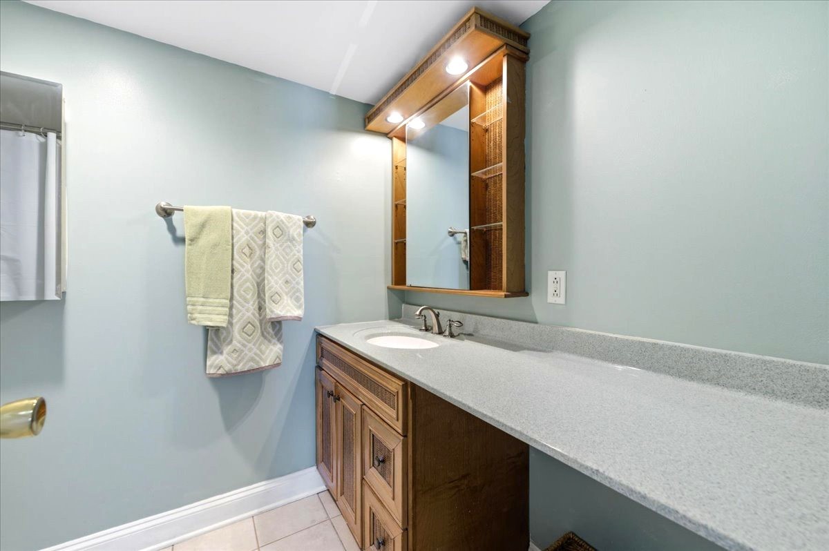 1311 South Finley Road, Unit 203 Lombard, IL 60148 - Photo 12 of 20 a bathroom with a sink and mirror