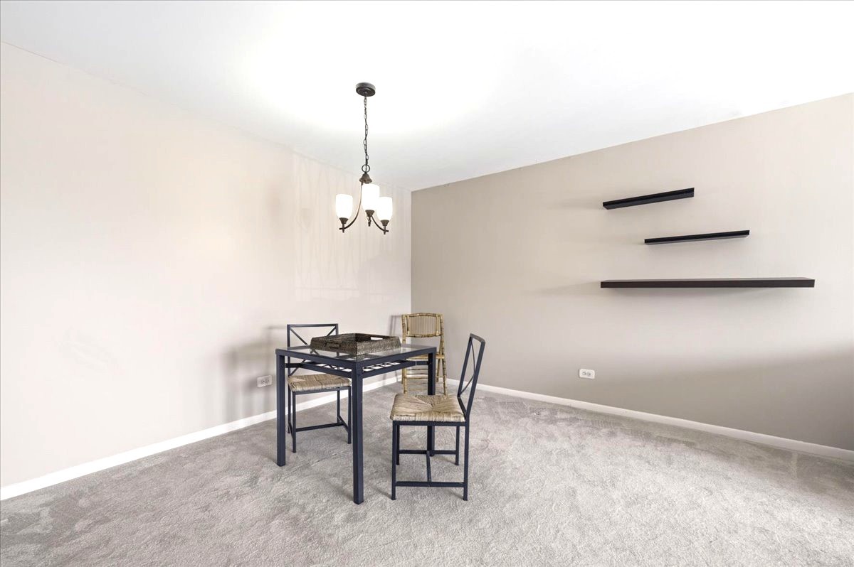 1311 South Finley Road, Unit 203 Lombard, IL 60148 - Photo 4 of 20 a view of a room with a table and chairs
