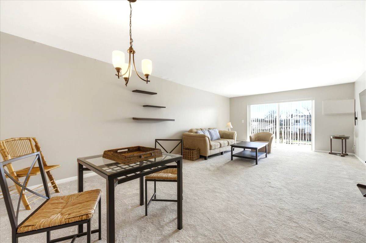 1311 South Finley Road, Unit 203 Lombard, IL 60148 - Photo 6 of 20 a living room with furniture and a chandelier