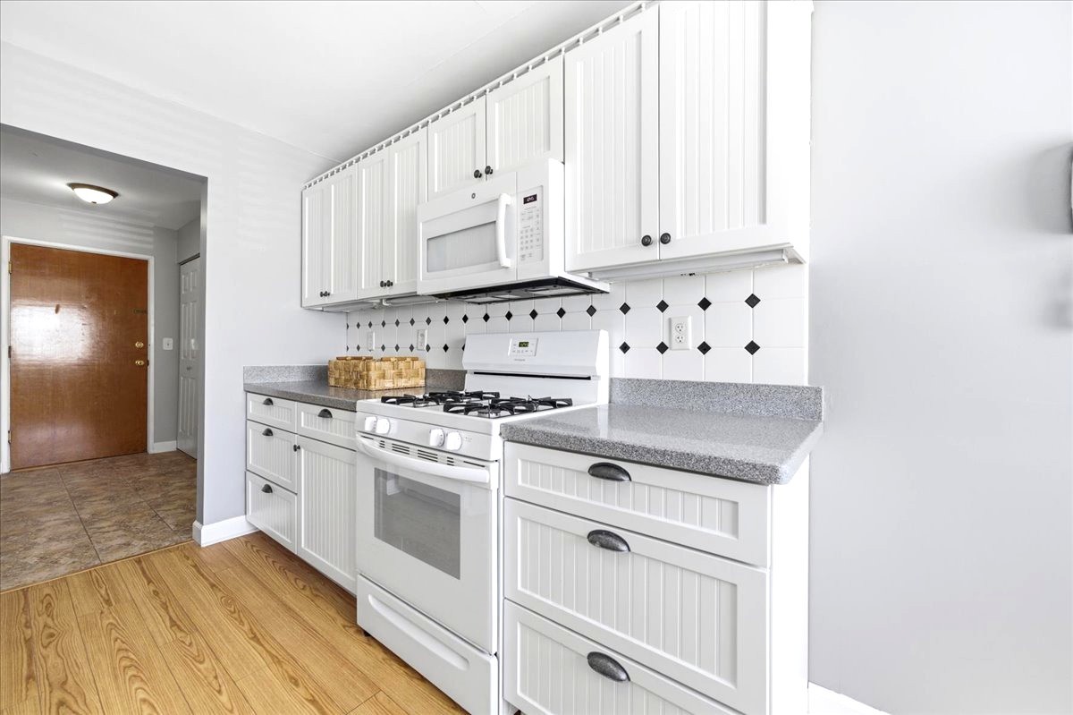 1311 South Finley Road, Unit 203 Lombard, IL 60148 - Photo 8 of 20 a kitchen with white cabinets and white appliances