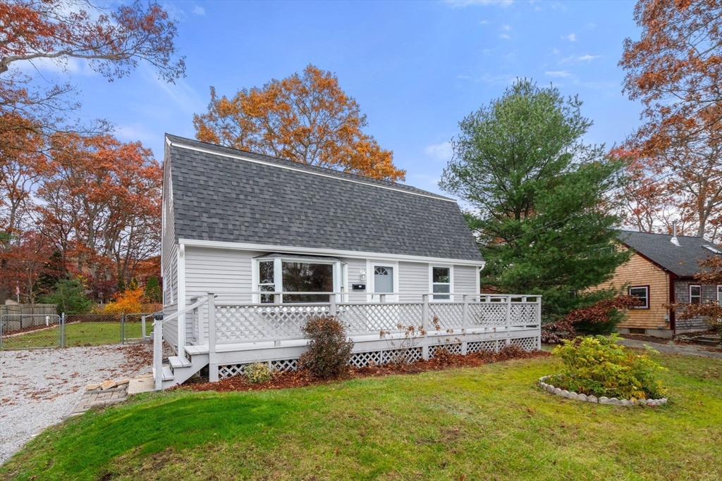 130 Old Barnstable Road Falmouth, MA 02536 - Photo 1 of 38 a front view of house with a garden and patio