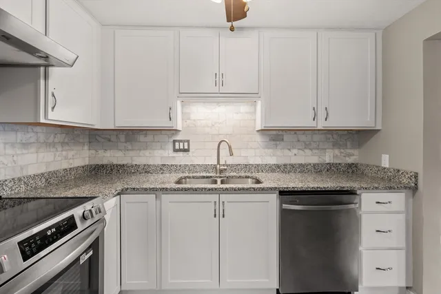 a kitchen with cabinets appliances and a sink