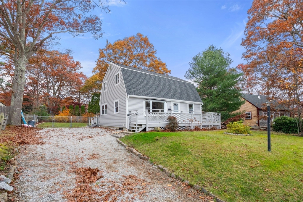 130 Old Barnstable Road Falmouth, MA 02536 - Photo 2 of 38 a front view of a house with a yard and garage