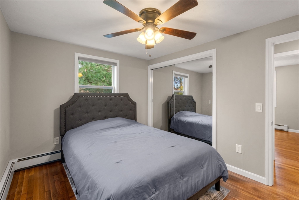 130 Old Barnstable Road Falmouth, MA 02536 - Photo 23 of 38 a bedroom with a bed and a chandelier