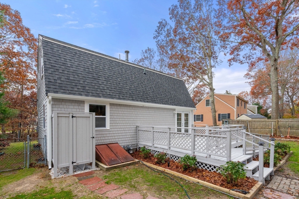130 Old Barnstable Road Falmouth, MA 02536 - Photo 30 of 38 a backyard of a house with lots of green space