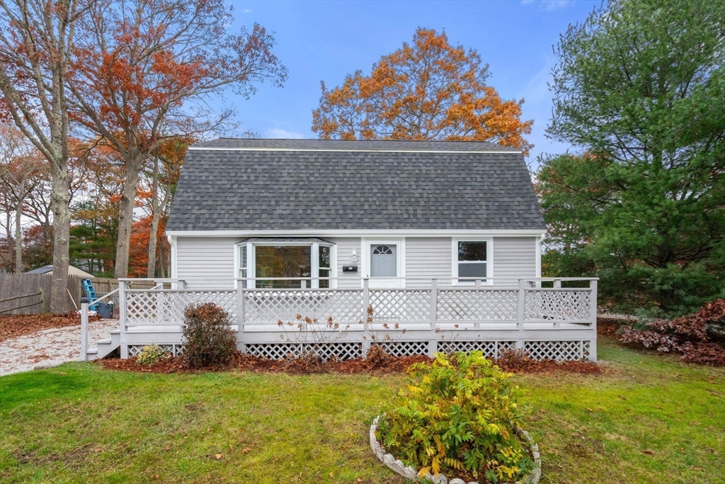 130 Old Barnstable Road Falmouth, MA 02536 - Photo 3 of 38 a front view of house with yard and trees in the background