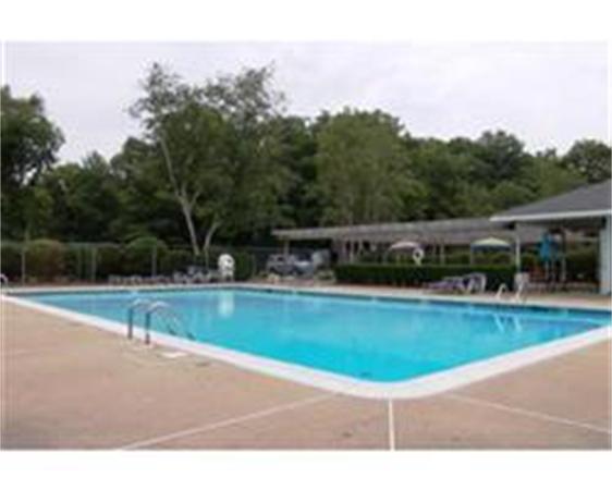 7 Beal's Cove Road, Unit 7G Hingham, MA 02043 - Photo 2 of 12 a view of a swimming pool with a yard
